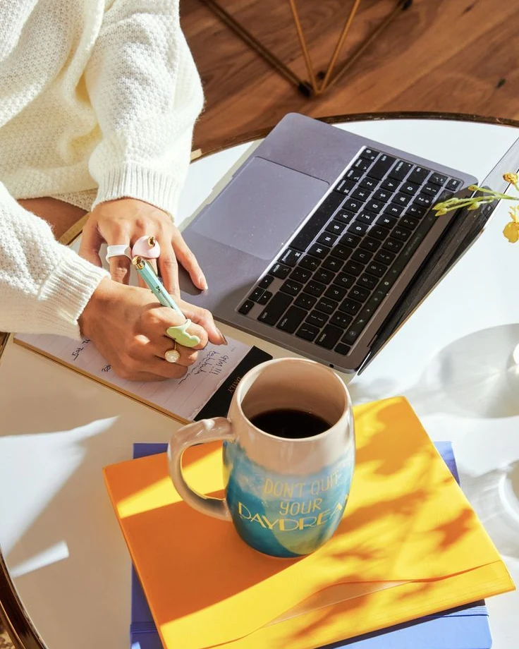 Planning a content calendar by hand next to a laptop